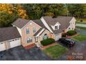 Aerial view of brick townhouses, showcasing driveways, landscaping, and surrounding trees at 200 W 18Th St, Newton, NC 28658
