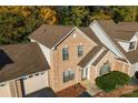 Aerial view of a brick townhouse highlighting the roof, landscaping, and attached garage at 200 W 18Th St, Newton, NC 28658