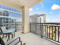 Balcony with furniture and a view of the surrounding buildings under a bright sky at 230 S Tryon St # 1111, Charlotte, NC 28202