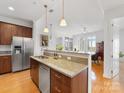 This open kitchen showcases granite counters, stainless appliances, and wood cabinets in a brightly lit space at 230 S Tryon St # 1111, Charlotte, NC 28202