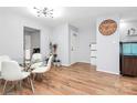 Dining room features hardwood floors, a glass table, and a large wall clock at 2900 Heathstead Pl # H, Charlotte, NC 28210