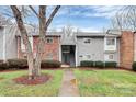 Charming two-story townhome with well-maintained landscaping, a brick facade, and a welcoming entrance at 2900 Heathstead Pl # H, Charlotte, NC 28210