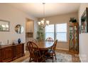 Traditional dining room with a wood table, chairs, and natural light from the windows at 3156 Pinehills Way, Mount Holly, NC 28120