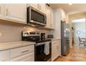 Updated kitchen featuring stainless steel appliances and classic subway tile backsplash at 3156 Pinehills Way, Mount Holly, NC 28120