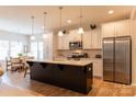 Spacious kitchen with a large center island, stainless appliances, and modern pendant lighting at 3156 Pinehills Way, Mount Holly, NC 28120