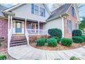 Charming two-story home with a combination of brick and siding, complemented by professionally landscaped front yard at 340 Tradewinds Ln, York, SC 29745