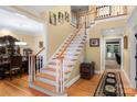 Inviting foyer with hardwood floors, staircase, and elegant decor at 3419 Wylie Meadow Ln, Charlotte, NC 28269