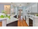 Bright kitchen features white cabinets, modern appliances, and hardwood floors at 618 Bayou Cir, Clover, SC 29710