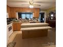 Open kitchen featuring an island with stone counters and wooden cabinets at 708 Mount Olive Church Rd, Newton, NC 28658
