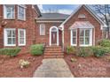 Inviting front entrance with brick steps and a detailed brick facade at 8000 Greencastle Dr, Charlotte, NC 28210