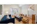 Bright living room with hardwood floors, ample seating, and a large bay window at 8000 Greencastle Dr, Charlotte, NC 28210