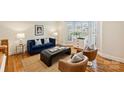 Cozy living room featuring hardwood floors, a large bay window, and comfortable seating at 8000 Greencastle Dr, Charlotte, NC 28210