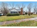 Charming brick home features a cozy screened-in porch and mature landscaping at 801 E Liberty St, Salisbury, NC 28144