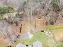 A peaceful backyard with a stone-lined walkway, grassy area, and wooded surroundings at 8143 Summit Ridge Dr # 41, Catawba, NC 28609