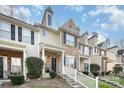 Charming two-story townhome with brick facade, black shutters, landscaped yard, and covered front porch at 8460 Summerglen Cir, Charlotte, NC 28227