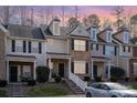 Charming two-story townhome with brick facade, black shutters, landscaped yard, and covered front porch at 8460 Summerglen Cir, Charlotte, NC 28227