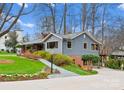 Inviting home with a well-maintained lawn and colorful landscaping, showcasing curb appeal and a backyard deck at 105 Hillside Dr, Davidson, NC 28036
