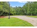 Long driveway leading to wooded lot with mature trees, professional landscaping, and ample privacy at 111 Kent Ct, Mooresville, NC 28117