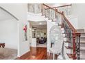Elegant foyer features hardwood floors, a staircase with iron railings, and decorative accents for a grand entrance at 12011 Olden Ct, Charlotte, NC 28262