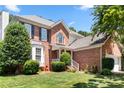 Beautiful brick home featuring manicured landscaping, an attached garage and classic architecture at 12541 Willingdon Rd, Huntersville, NC 28078