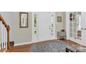 Inviting foyer features hardwood floors, a white front door, and soft natural light at 12541 Willingdon Rd, Huntersville, NC 28078