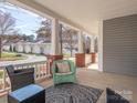 Inviting covered front porch with comfortable seating and a view of the neighborhood at 13245 Chelsea Ridge Ln, Huntersville, NC 28078