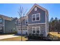 Beautiful two-story home with blue siding, stone accents, and a well-maintained front lawn at 133 Batten Ridge Dr, Statesville, NC 28677