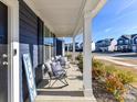 Cozy front porch furnished with comfortable seating, offering a relaxing outdoor space with neighborhood views at 1444 Harleston St, Indian Trail, NC 28079