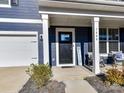 Inviting front porch features classic white columns, providing a welcoming entrance to the home with a 'Welcome' sign at 1444 Harleston St, Indian Trail, NC 28079