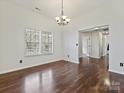 Spacious dining area featuring hardwood floors, natural light, and a stylish chandelier at 14621 Sapphire Ln, Pineville, NC 28134