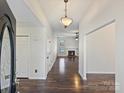 Inviting foyer showcasing gleaming hardwood floors and a view of the fireplace, perfect for welcoming guests at 14621 Sapphire Ln, Pineville, NC 28134