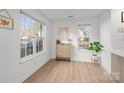 Bright living area with hardwood floors, large windows, and space for personalized decor at 1503 Briar Creek Rd # Apt B, Charlotte, NC 28205