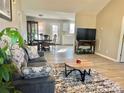 Inviting living room with open layout to dining area, features modern flooring and comfortable seating at 164 Basset Cir, Salisbury, NC 28146