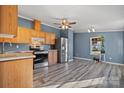 Open-concept kitchen with stainless steel appliances and modern flooring at 166 Sonja Dr, Statesville, NC 28677