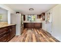 Updated kitchen with stainless steel appliances, dark cabinetry, granite countertops, and wood-look flooring at 1759 Smith Ave, Gastonia, NC 28052