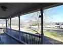 Inviting covered porch with white railings offering a scenic view of the neighborhood at 2087 Serenity Ln, Rock Hill, SC 29730