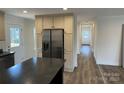 Bright kitchen showcasing stainless steel appliances and ample cabinet space, seamlessly connected to a hallway at 238 Fairchase Cir # 54, Stony Point, NC 28678