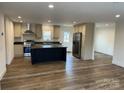 Spacious kitchen featuring a large island, stainless steel appliances, and hardwood flooring at 238 Fairchase Cir # 54, Stony Point, NC 28678