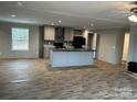 Open concept view of the kitchen island with modern appliances and grey cabinets at 252 Fairchase Cir # 56, Stony Point, NC 28678