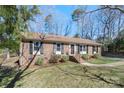 All brick home with a well-maintained lawn and beautiful, mature trees at 2537 Wood Star Ct, Matthews, NC 28105