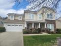 Inviting two-story home with a covered front porch and manicured lawn at 3216 Bridgewick Rd, Waxhaw, NC 28173