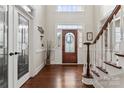 Welcoming foyer with hardwood floors, elegant front door, and a staircase with wood accents at 4608 Snow Dr, Harrisburg, NC 28075