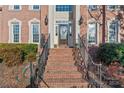 Inviting brick stairway leading to the front door with decorative wreath and stylish sconces at 4608 Snow Dr, Harrisburg, NC 28075
