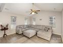 Bright living room featuring a large sectional sofa, wood floors, vaulted ceiling with fan, and natural light at 6622 Cedar Cliff Dr, Charlotte, NC 28216