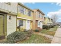 A row of charming townhouses, each with unique siding and well-maintained front yards at 7344 Pebblestone Dr # E, Charlotte, NC 28212