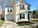 Charming two-story home with attached garage and a well-manicured lawn at 7702 Brisbane Ct, Charlotte, NC 28215