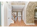 Inviting foyer with hardwood floors, staircase, and an arched entrance at 7713 Dunoon Ln, Charlotte, NC 28269