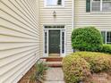 View of the front door with decorative trim and a green paint color at 7713 Dunoon Ln, Charlotte, NC 28269