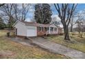 View of the brick home with attached garage and concrete driveway at 821 Cabaniss Dr, Shelby, NC 28150
