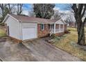 View of brick home with attached garage and concrete driveway at 821 Cabaniss Dr, Shelby, NC 28150